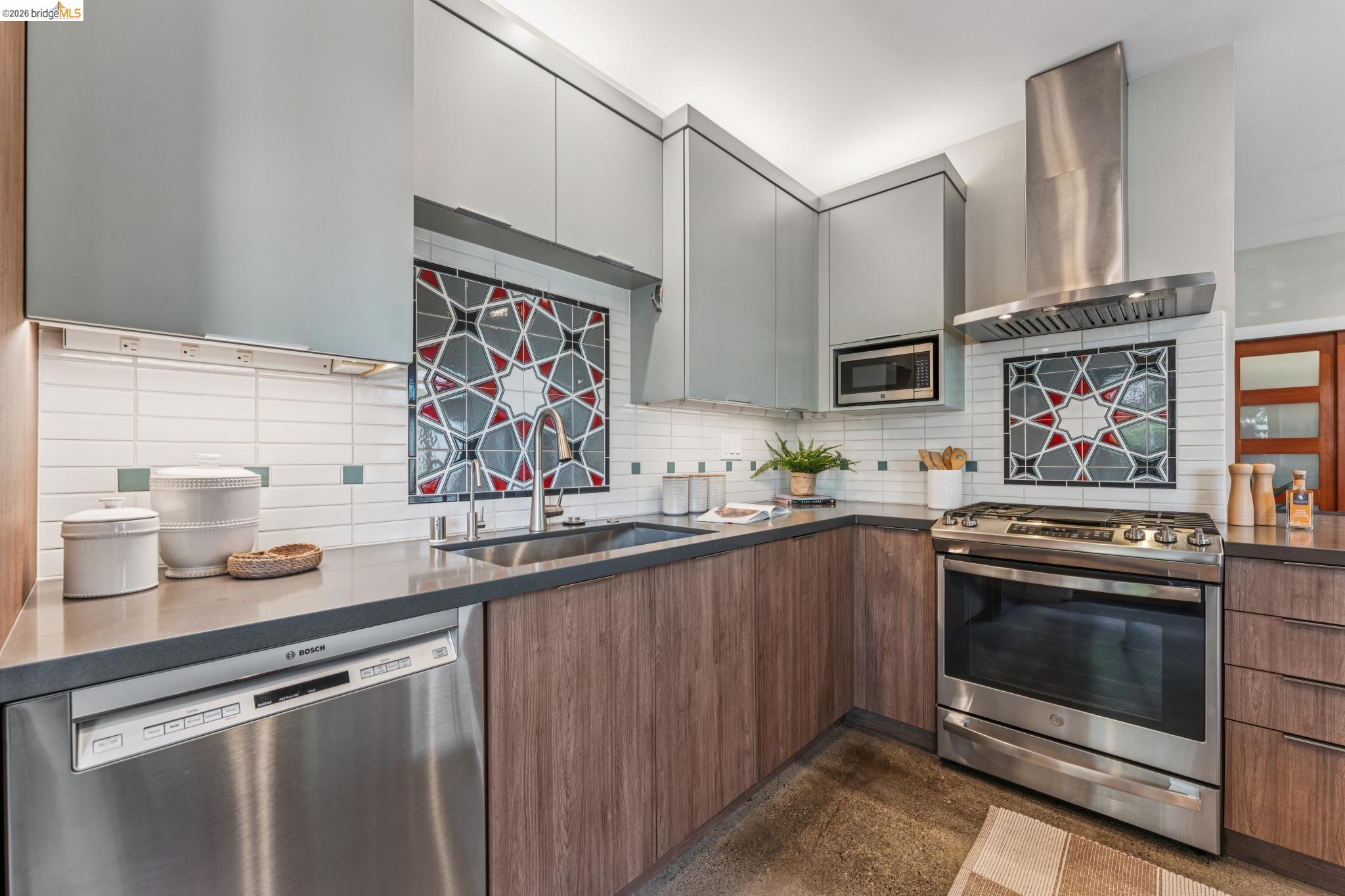 829 21st Street, Unit 1 Oakland, CA 94607 - Photo 17 of 46 a kitchen with stainless steel appliances a stove sink and cabinets