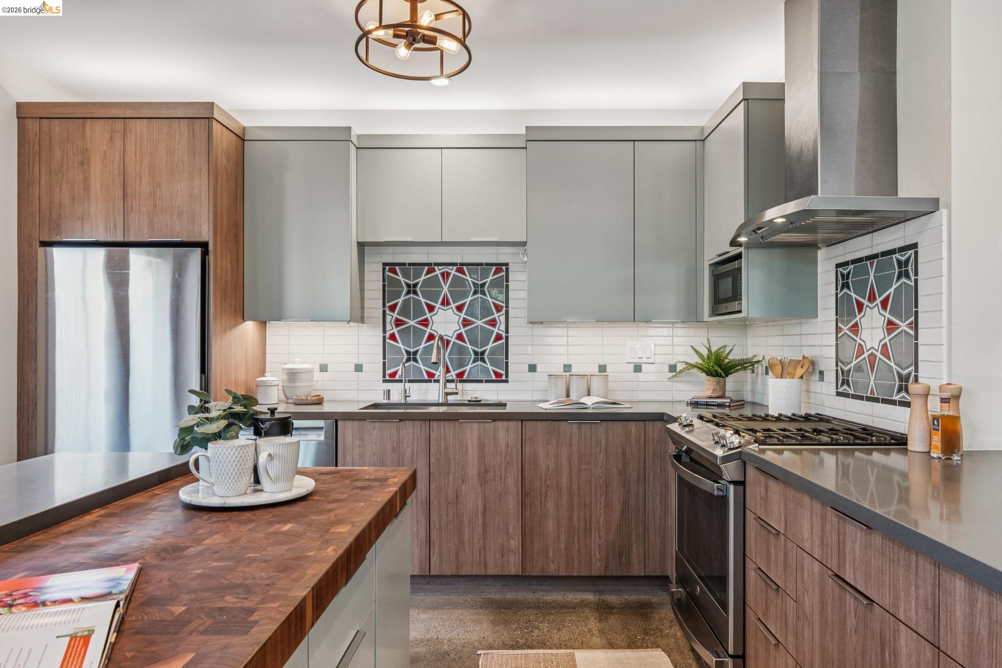 829 21st Street, Unit 1 Oakland, CA 94607 - Photo 20 of 46 a kitchen with stainless steel appliances granite countertop a sink stove and refrigerator
