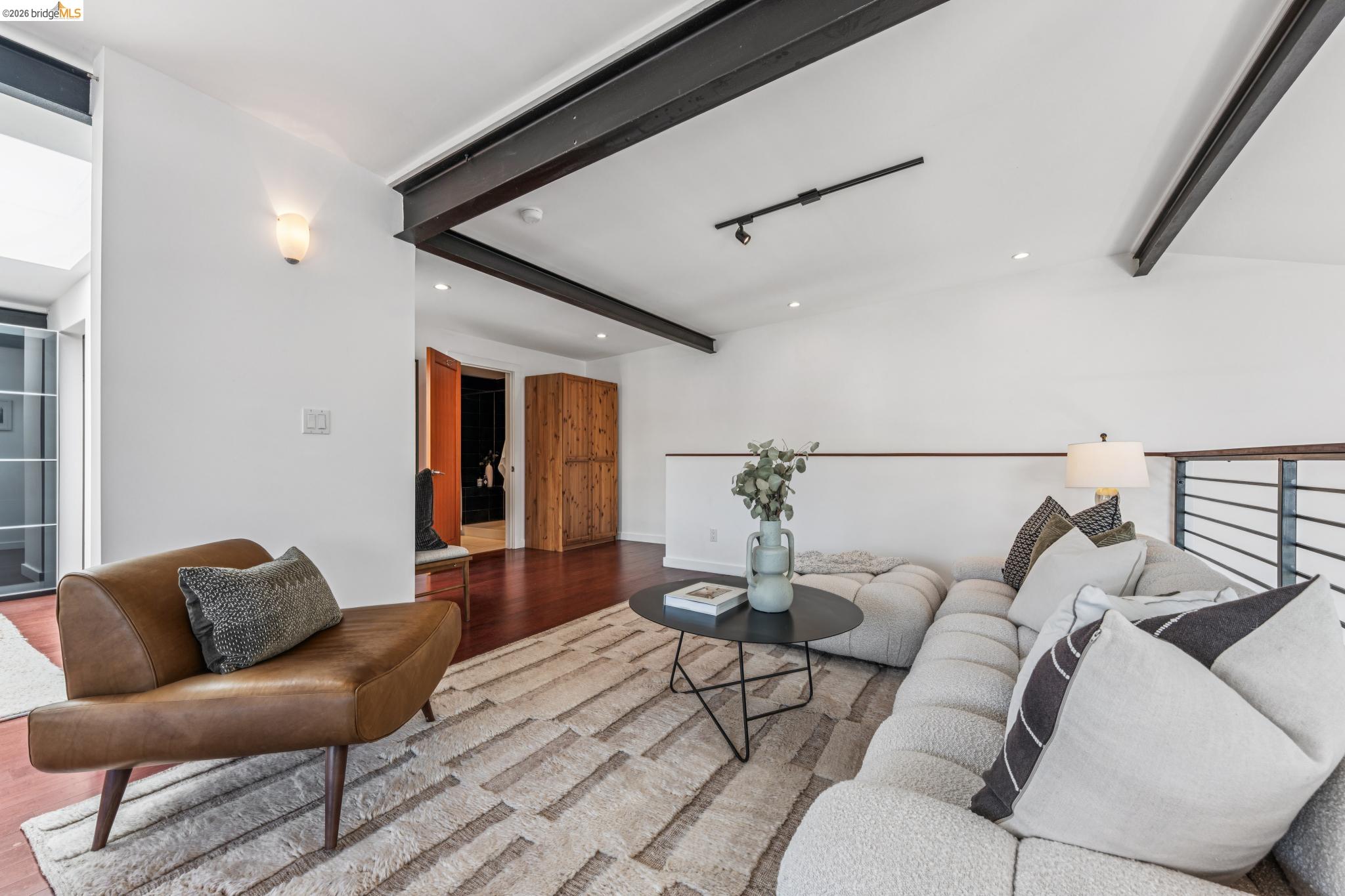 829 21st Street, Unit 1 Oakland, CA 94607 - Photo 24 of 46 a living room with furniture and wooden floor