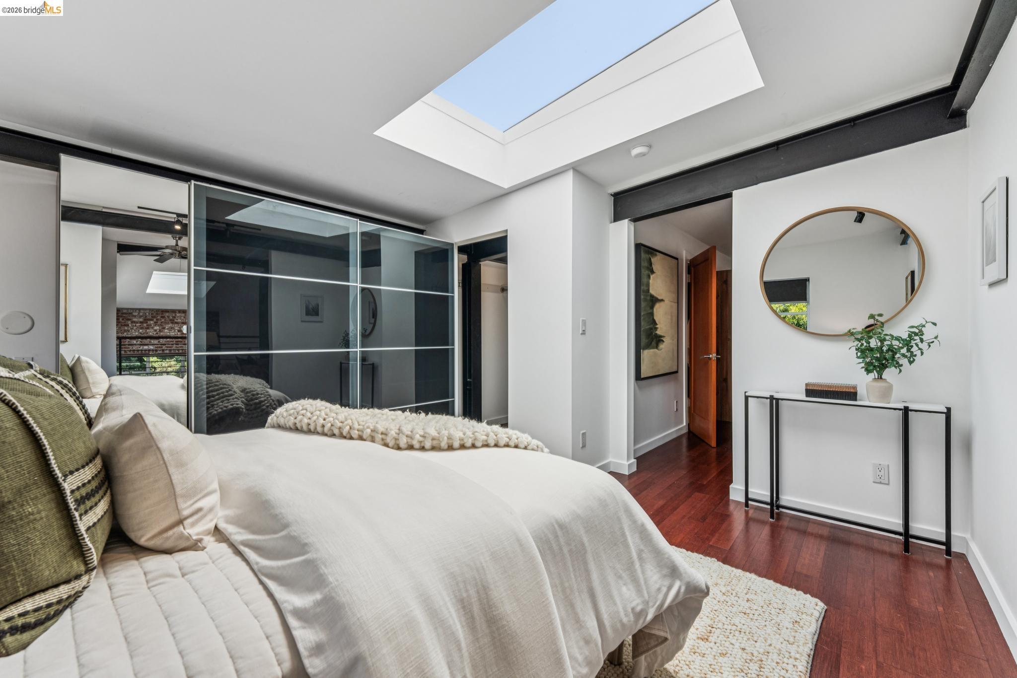 829 21st Street, Unit 1 Oakland, CA 94607 - Photo 27 of 46 a bedroom with a bed a potted plant and a large window