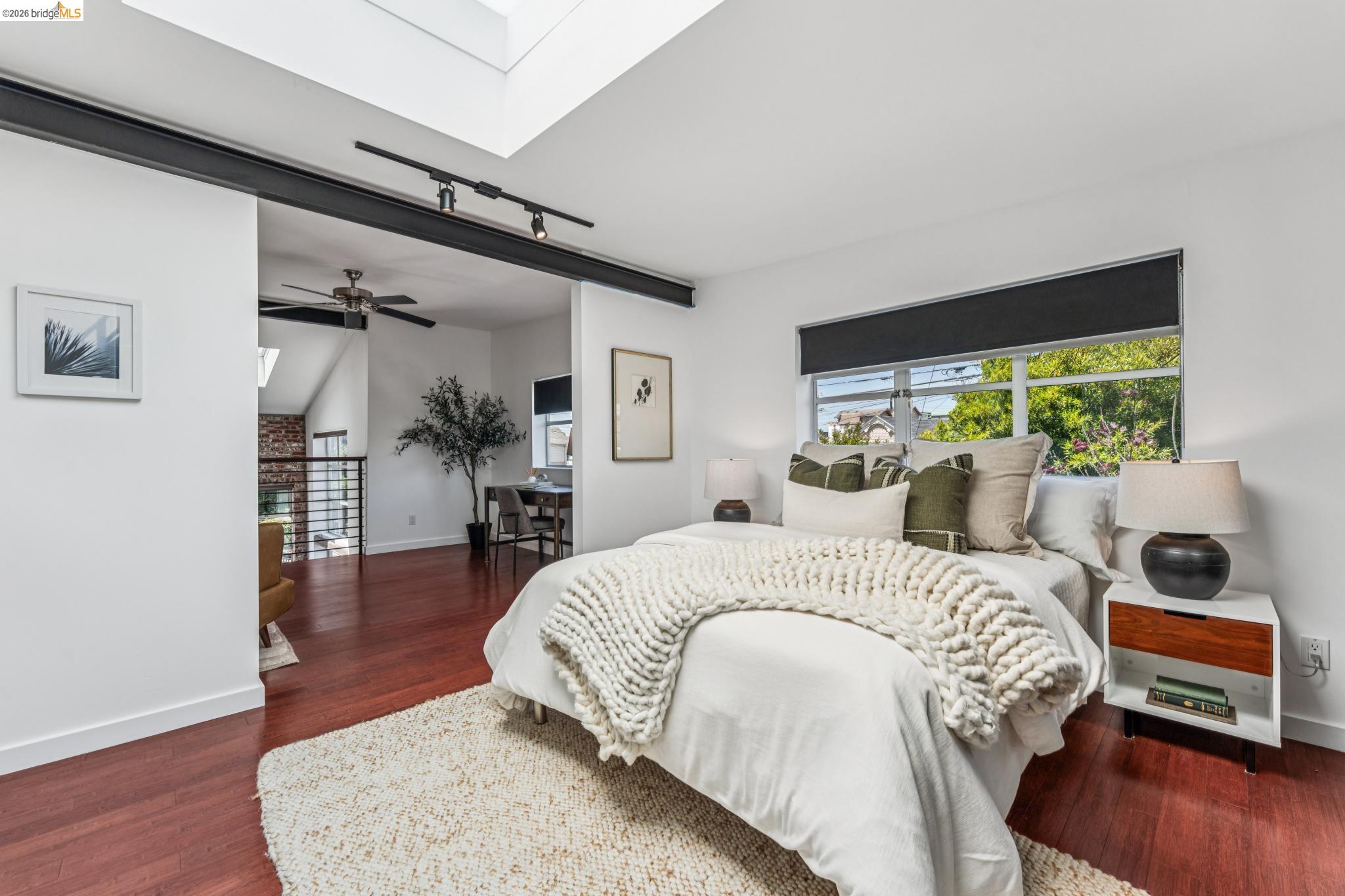 829 21st Street, Unit 1 Oakland, CA 94607 - Photo 29 of 46 a bedroom with a bed and wooden floor