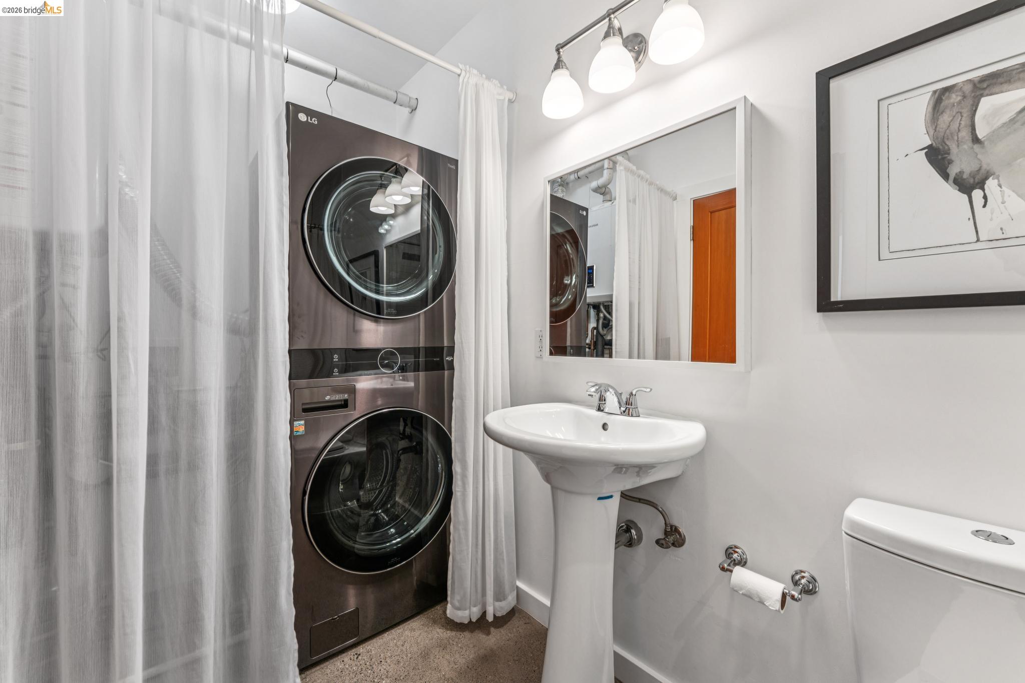 829 21st Street, Unit 1 Oakland, CA 94607 - Photo 34 of 46 a bathroom with a sink a mirror and a toilet