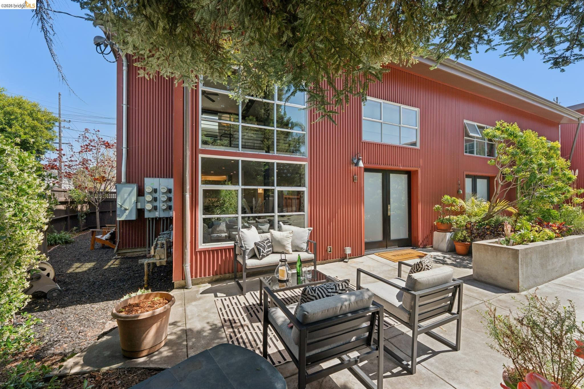 829 21st Street, Unit 1 Oakland, CA 94607 - Photo 38 of 46 a view of a patio with a chairs and table in a patio