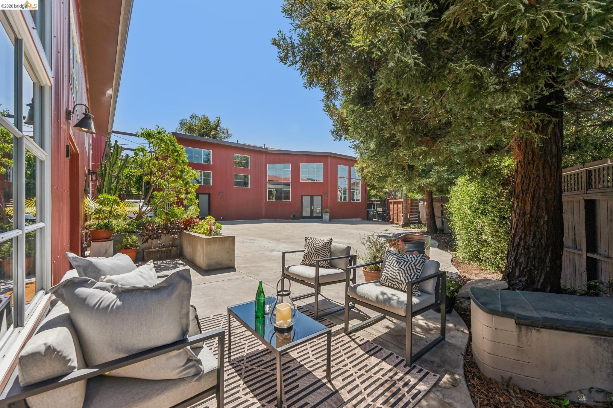 829 21st Street, Unit 1 Oakland, CA 94607 - Photo 39 of 46 a view of a patio with couches table and chairs and potted plants