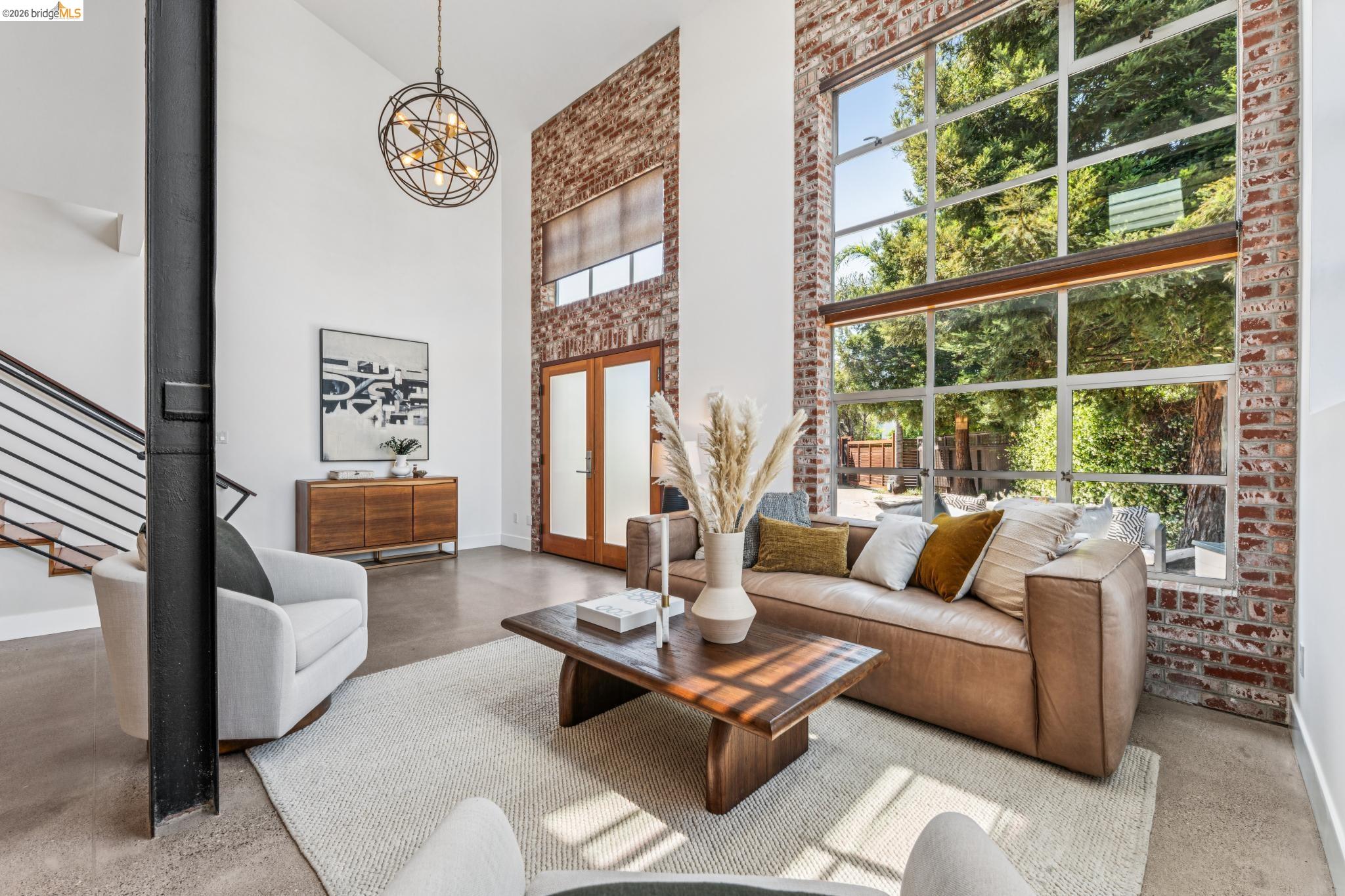 829 21st Street, Unit 1 Oakland, CA 94607 - Photo 5 of 46 a living room with furniture and a floor to ceiling window