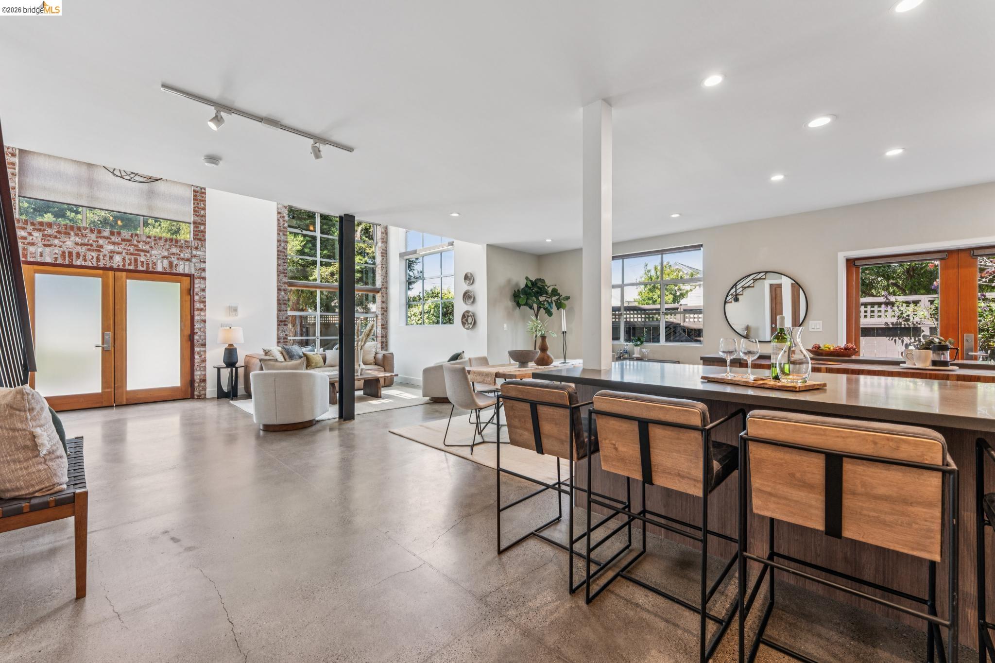 829 21st Street, Unit 1 Oakland, CA 94607 - Photo 9 of 46 a dining hall with stainless steel appliances granite countertop a stove a sink a dining table and chairs with wooden floor