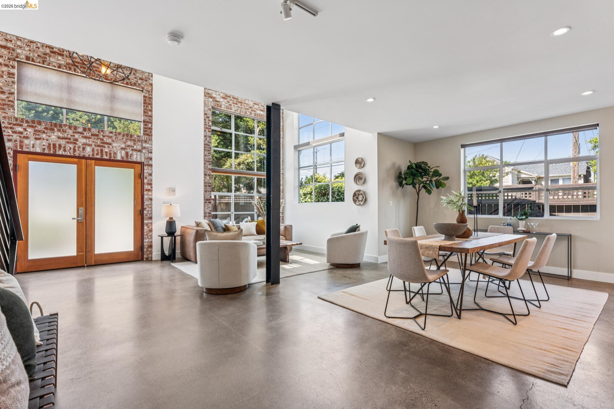 829 21st Street, Unit 1 Oakland, CA 94607 - Photo 10 of 46 a living room with furniture and floor to ceiling windows