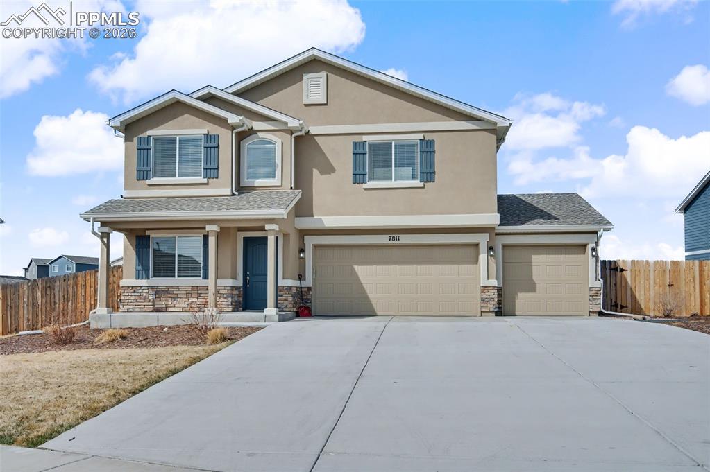 7811 Berwyn Loop Peyton, CO 80831 - Photo 1 of 38 a front view of a house with a yard and garage