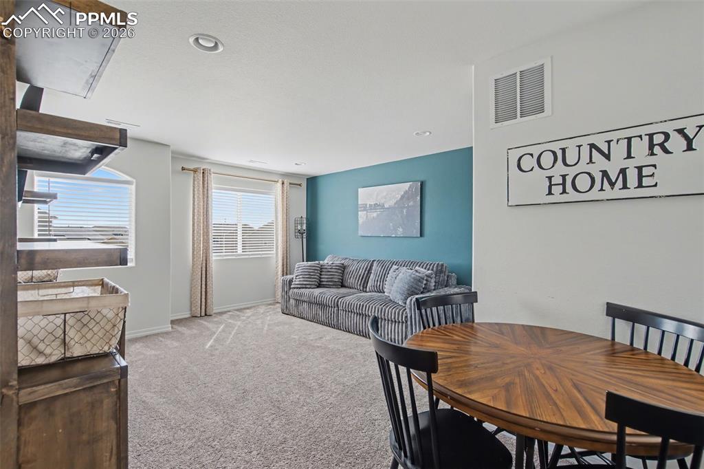 7811 Berwyn Loop Peyton, CO 80831 - Photo 22 of 38 a living room with furniture and a flat screen tv