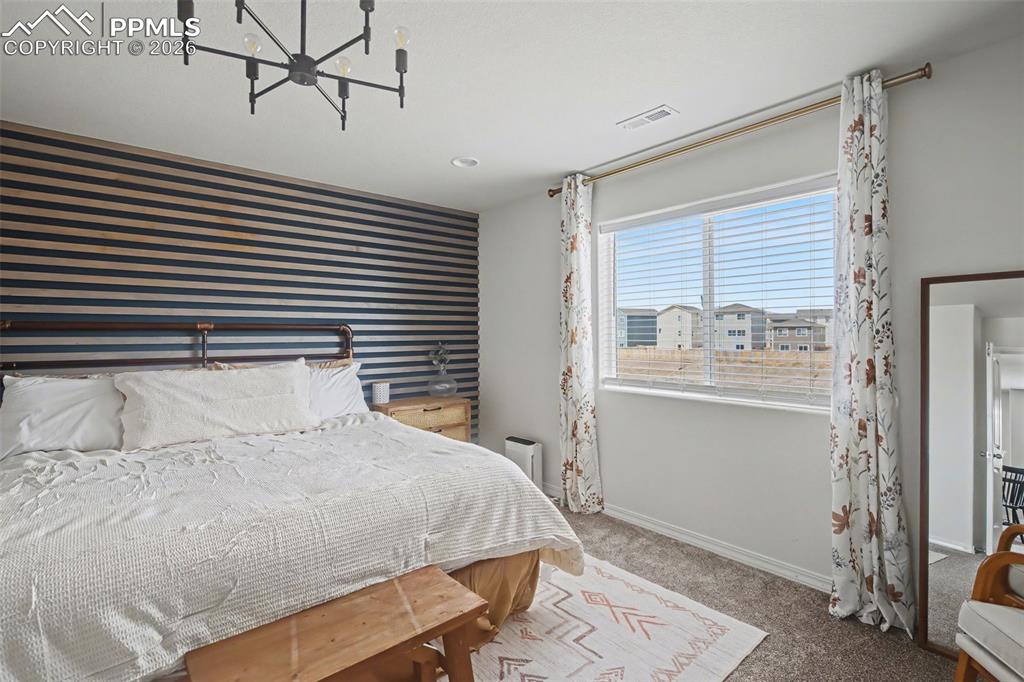 7811 Berwyn Loop Peyton, CO 80831 - Photo 24 of 38 a bedroom with a bed and a window