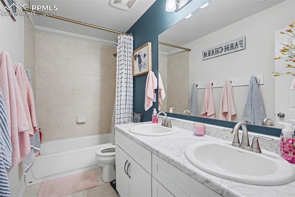 7811 Berwyn Loop Peyton, CO 80831 - Photo 32 of 38 a bathroom with a granite countertop sink toilet and shower