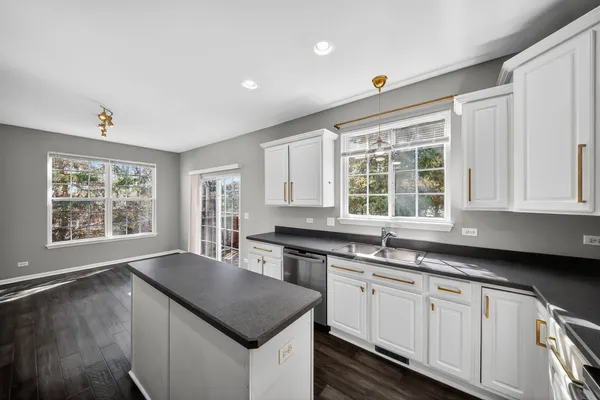 a kitchen with stainless steel appliances a sink a stove a refrigerator cabinets and a counter top space