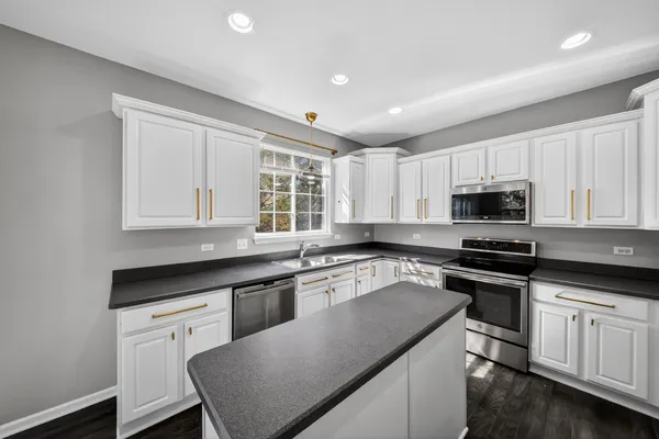 a kitchen with stainless steel appliances granite countertop refrigerator sink and cabinets