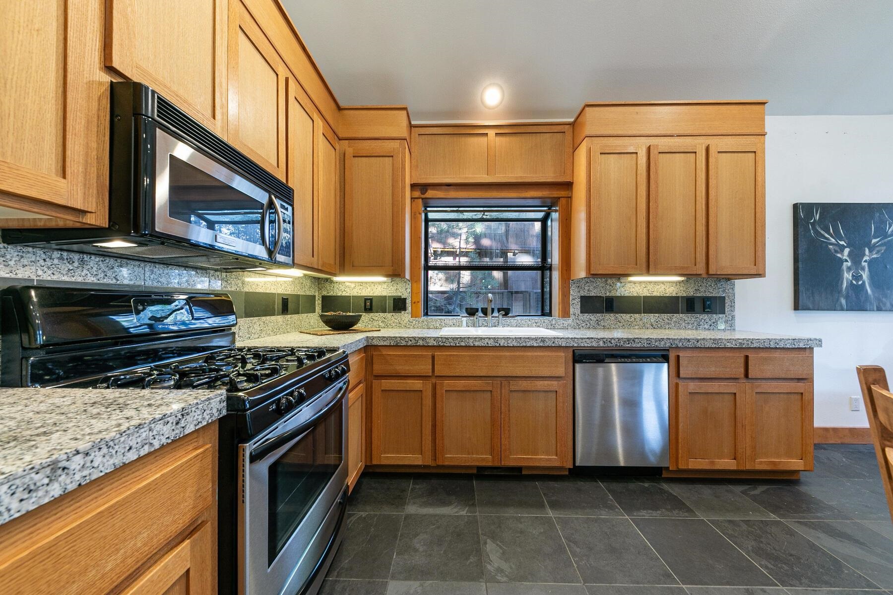 14580 Donner Pass Road Truckee, CA 96161 - Photo 13 of 27 a kitchen with stainless steel appliances granite countertop a stove sink and cabinets
