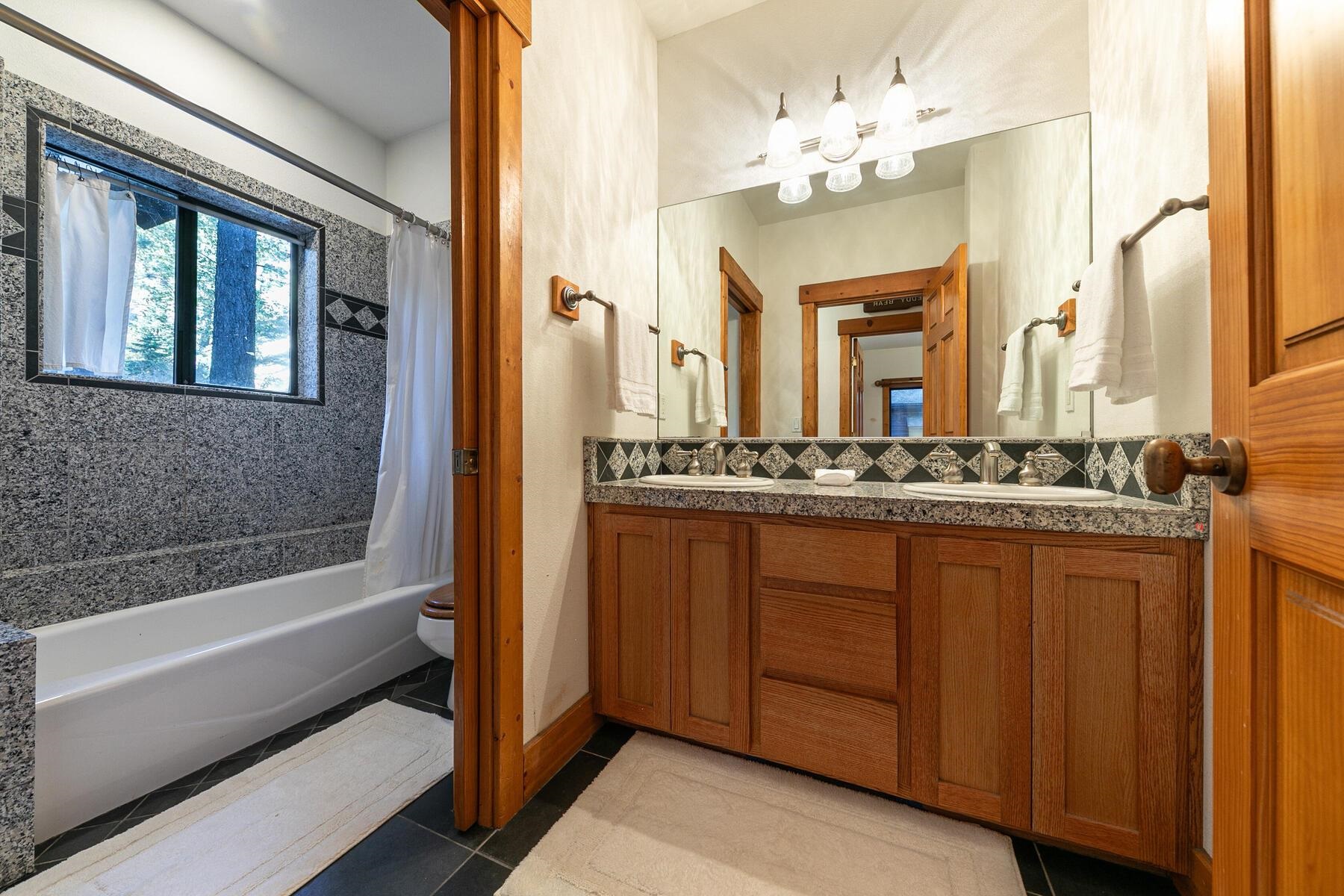 14580 Donner Pass Road Truckee, CA 96161 - Photo 20 of 27 a bathroom with a double vanity sink mirror and bathtub