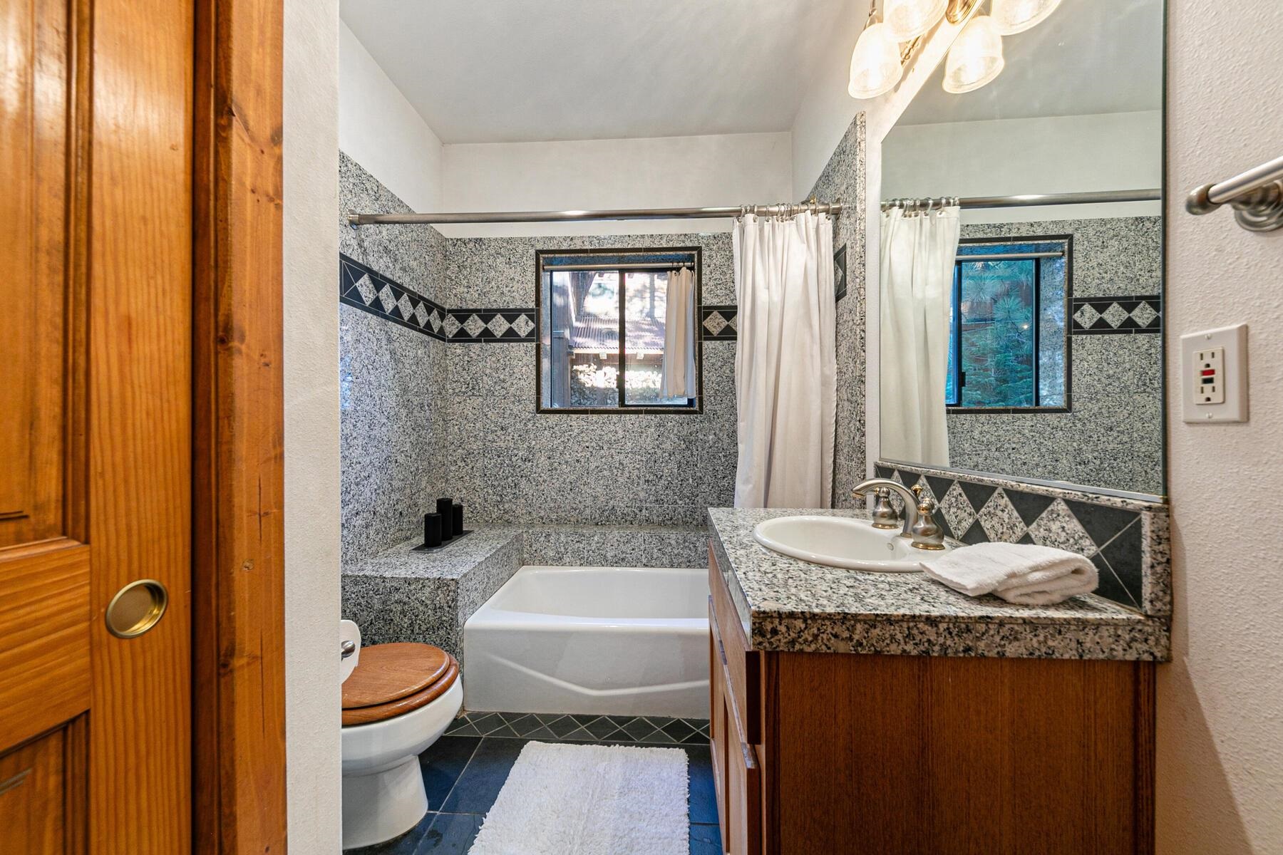 14580 Donner Pass Road Truckee, CA 96161 - Photo 22 of 27 a bathroom with a granite countertop sink toilet and shower