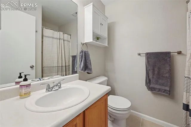 a bathroom with a sink toilet and mirror
