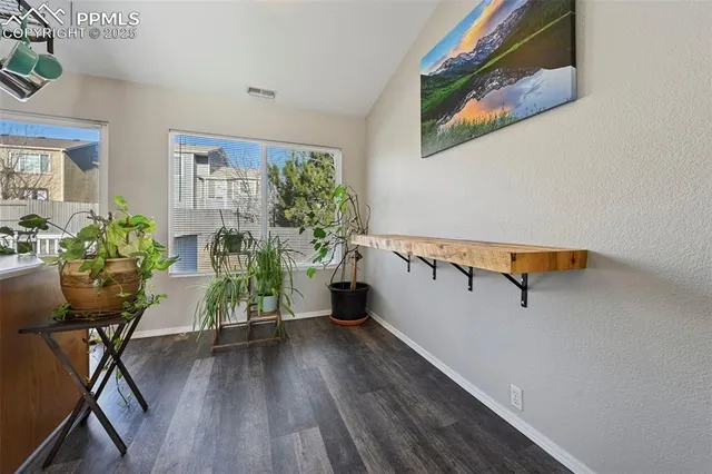 a view of a room with wooden floor and windows