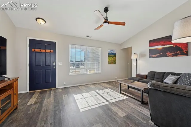 a living room with furniture and wooden floor