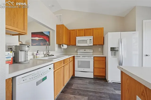 a kitchen with stainless steel appliances granite countertop a refrigerator sink and stove