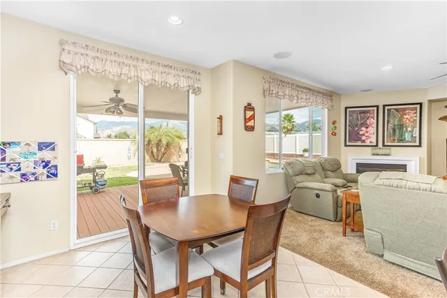 a view of a dining room with furniture and a large window