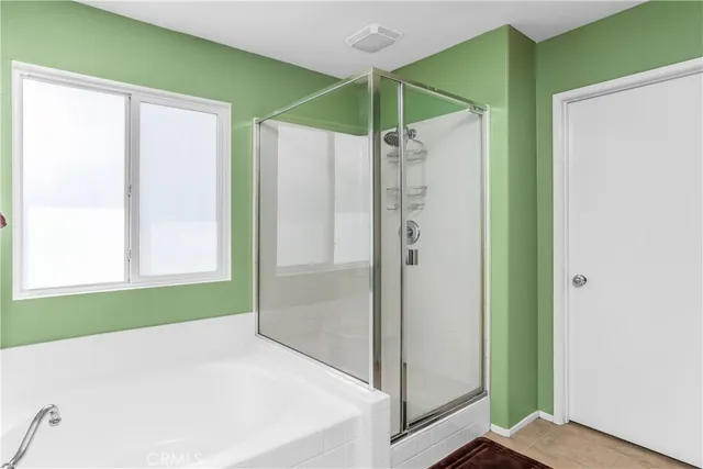 a bathroom with a shower and a glass door