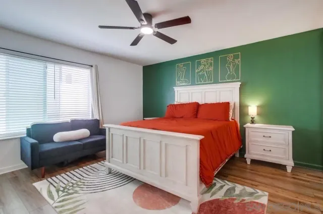 a bedroom with a bed and a couch