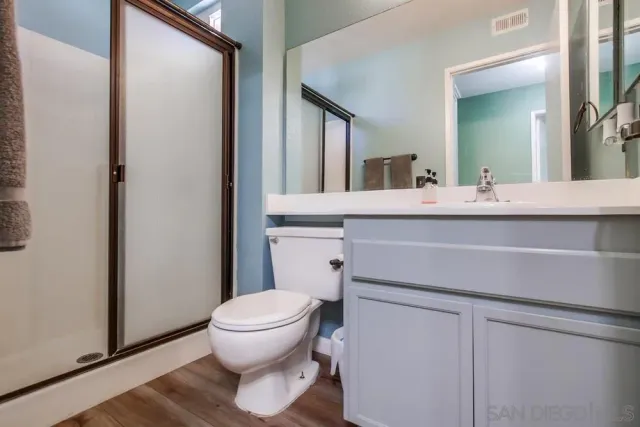 a bathroom with a sink toilet and mirror