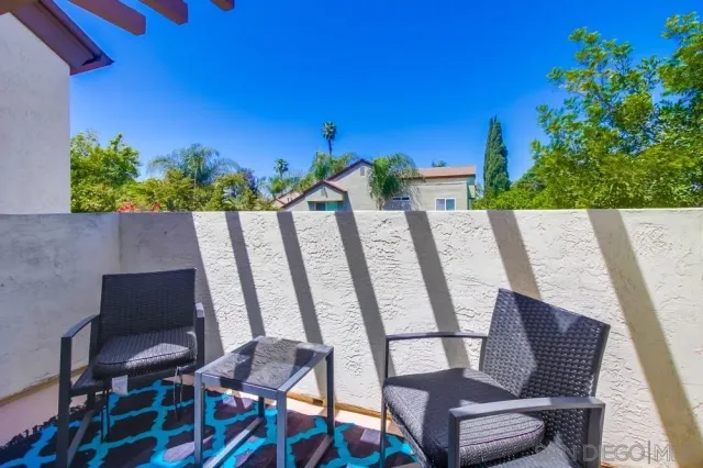 a view of a chair and table in the balcony