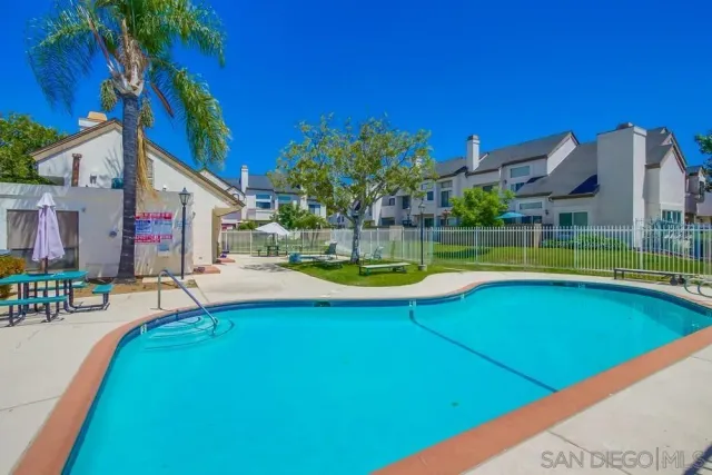 a view of a house with swimming pool and porch