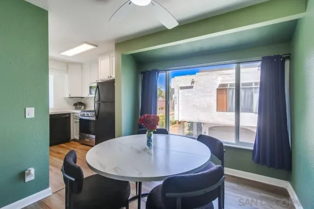 a large kitchen with a table and chairs