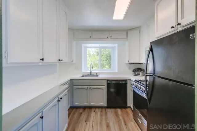 a kitchen with a sink stove and refrigerator
