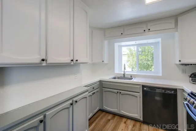 a kitchen with a sink stove and cabinets