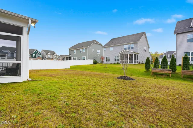 a view of an house with swimming pool garden and trees