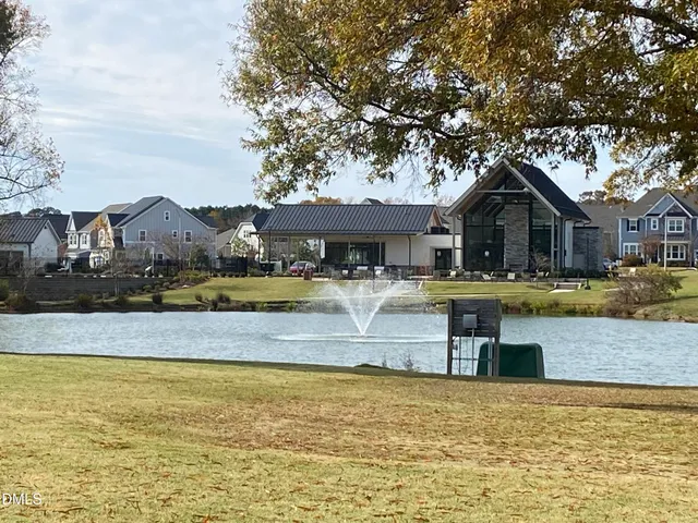 a view of a house with swimming pool and a yard