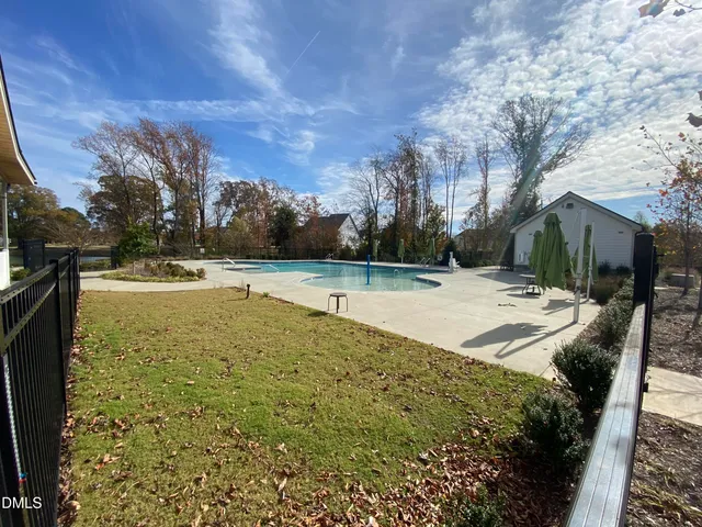 a view of swimming pool with a yard
