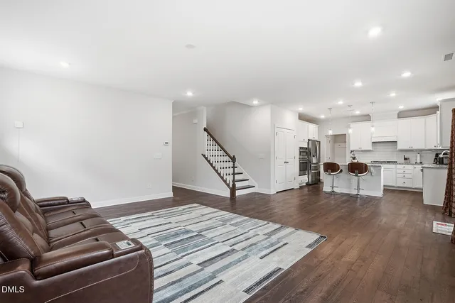 a living room with furniture and kitchen view