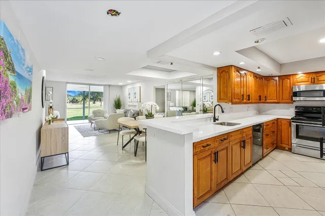 a large white kitchen with a large window