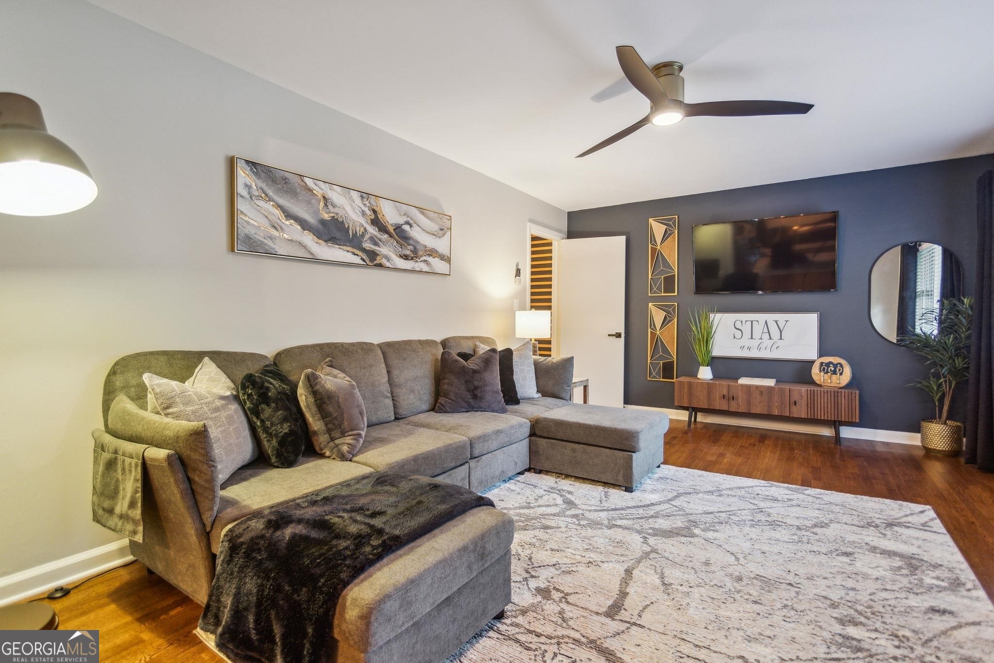 a living room with furniture and a flat screen tv