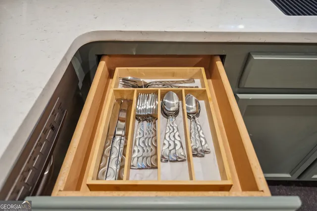 a large white kitchen with a large window