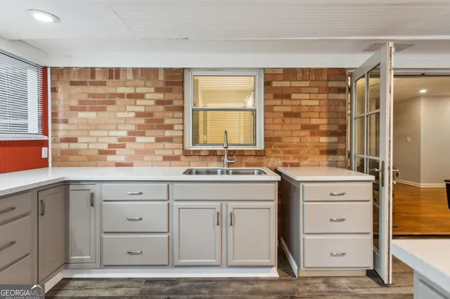 a kitchen with granite countertop white cabinets and white appliances