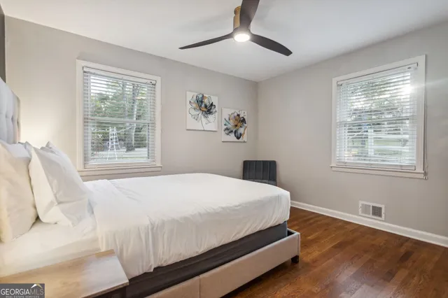 a bedroom with a bed and a large window