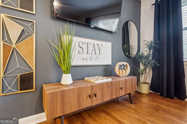 a view of a dresser and couch in a hallway