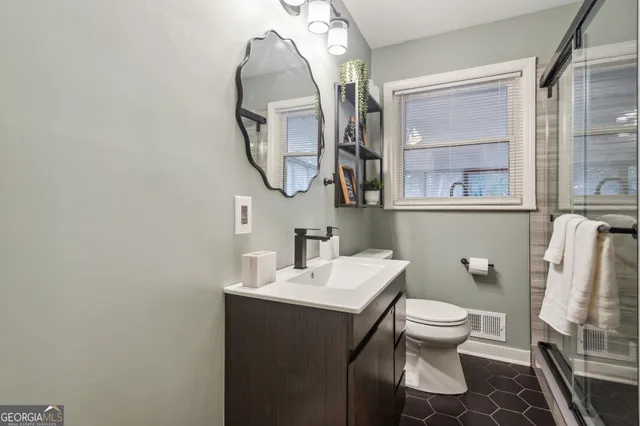 a bathroom with a toilet and a shower