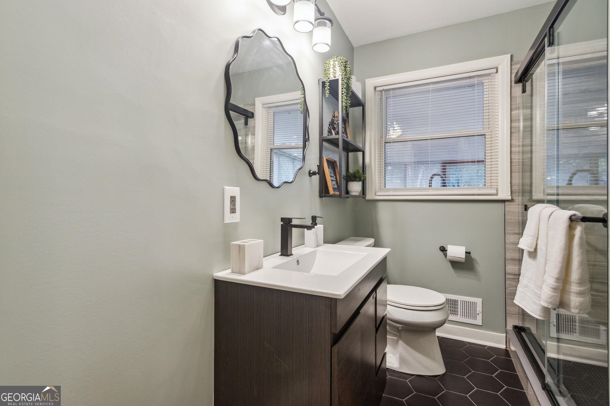 425 Plantation Road Southwest Smyrna, GA 30082 - Photo 22 of 42 a bathroom with a sink and a mirror