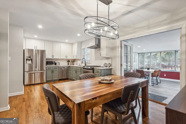 a view of a dining room and kitchen island with furniture