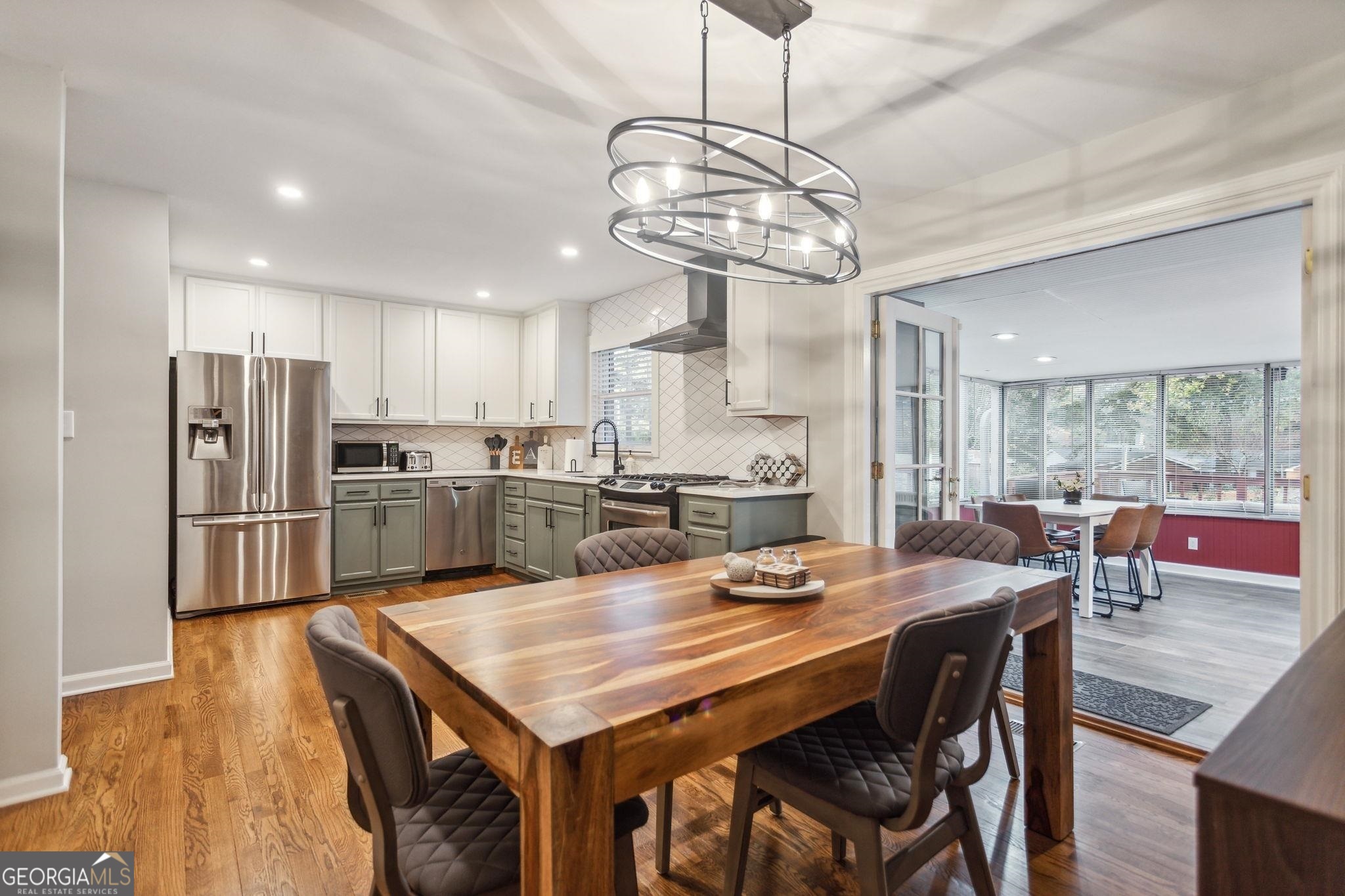 425 Plantation Road Southwest Smyrna, GA 30082 - Photo 3 of 42 a view of a dining room and kitchen island with furniture