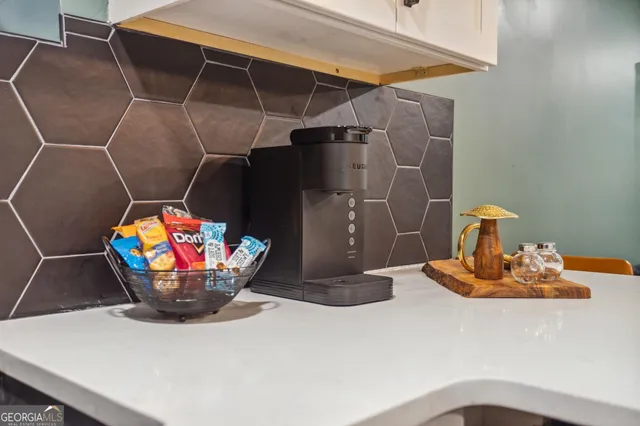 a backyard of a house with wooden floor and outdoor seating