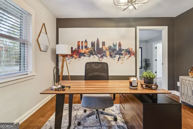 a living room with table and chairs