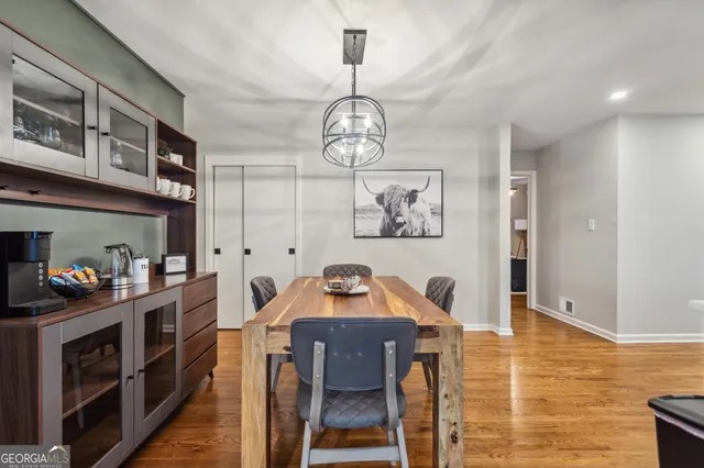 a view of a room with wooden floor and furniture